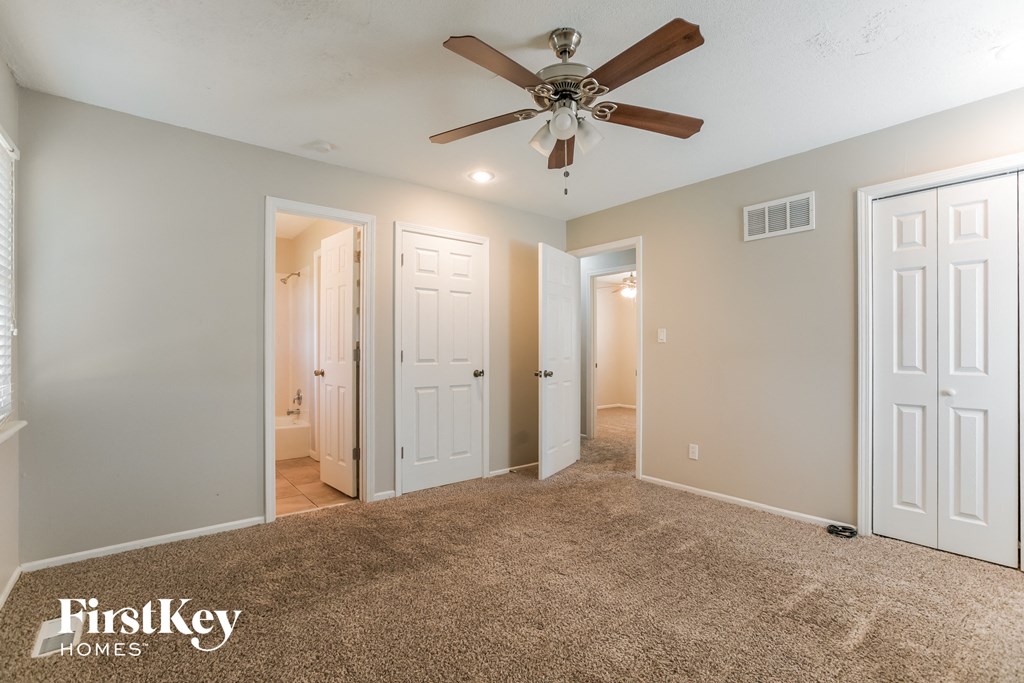 the master bedroom is spacious and has a ceiling fan