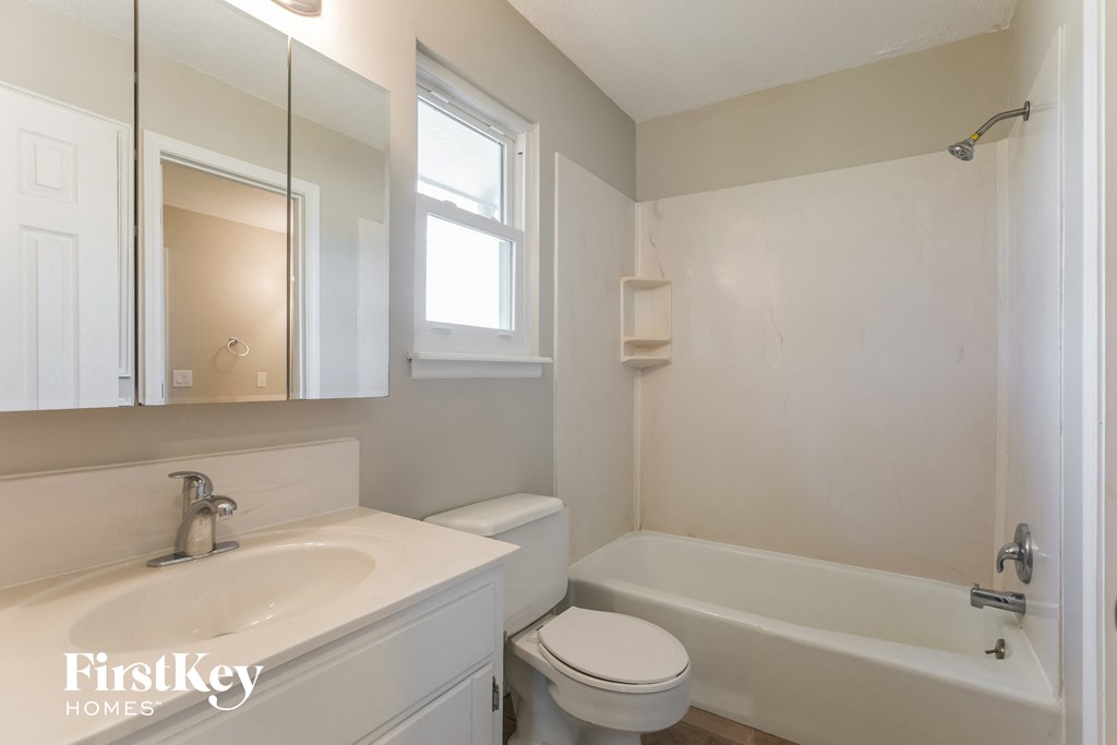 a bathroom with a sink toilet and a bath tub