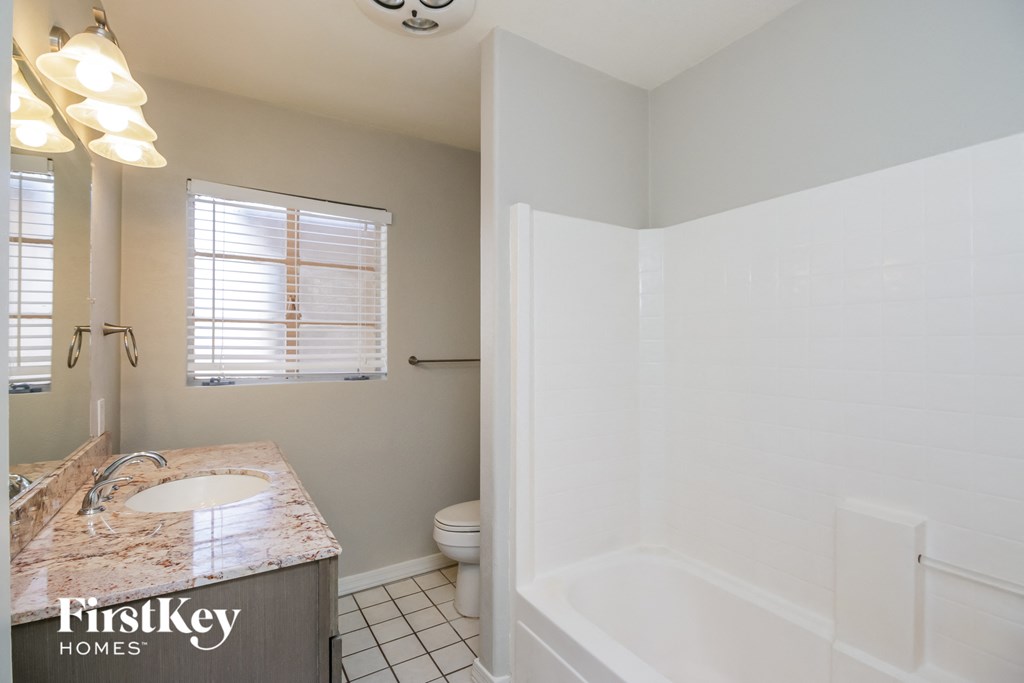 a bathroom with a shower and a sink and a toilet