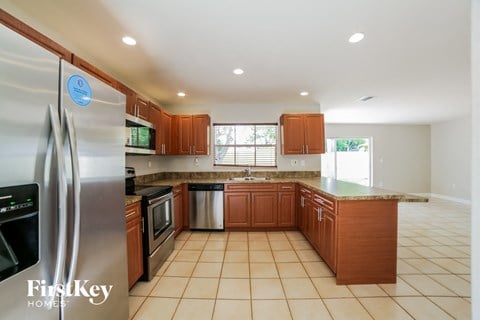 full view of the kitchen with stainless steel appliances and wooden cabinets