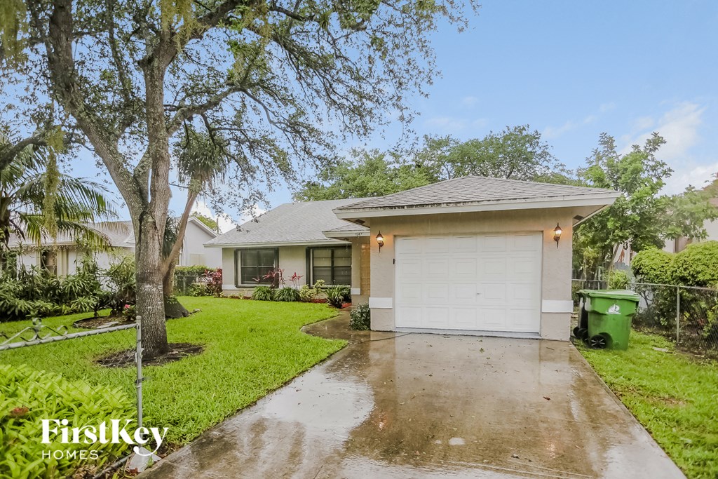 a home with a driveway and a white garage door