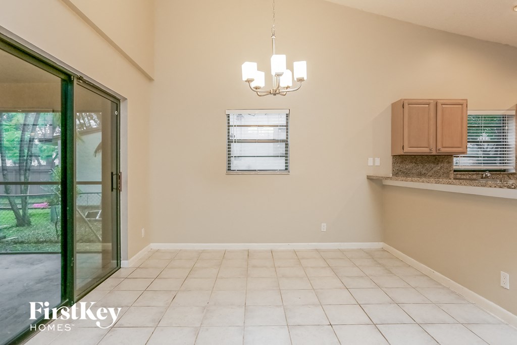 an empty dining room with a door to the backyard