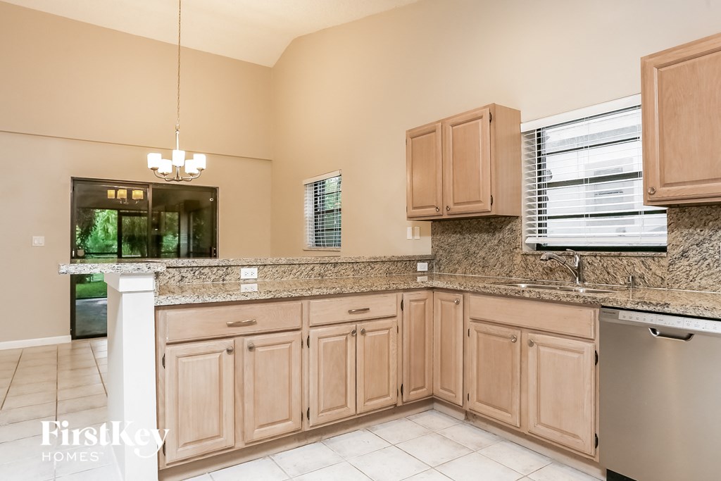 a kitchen with wooden cabinets and granite counter tops