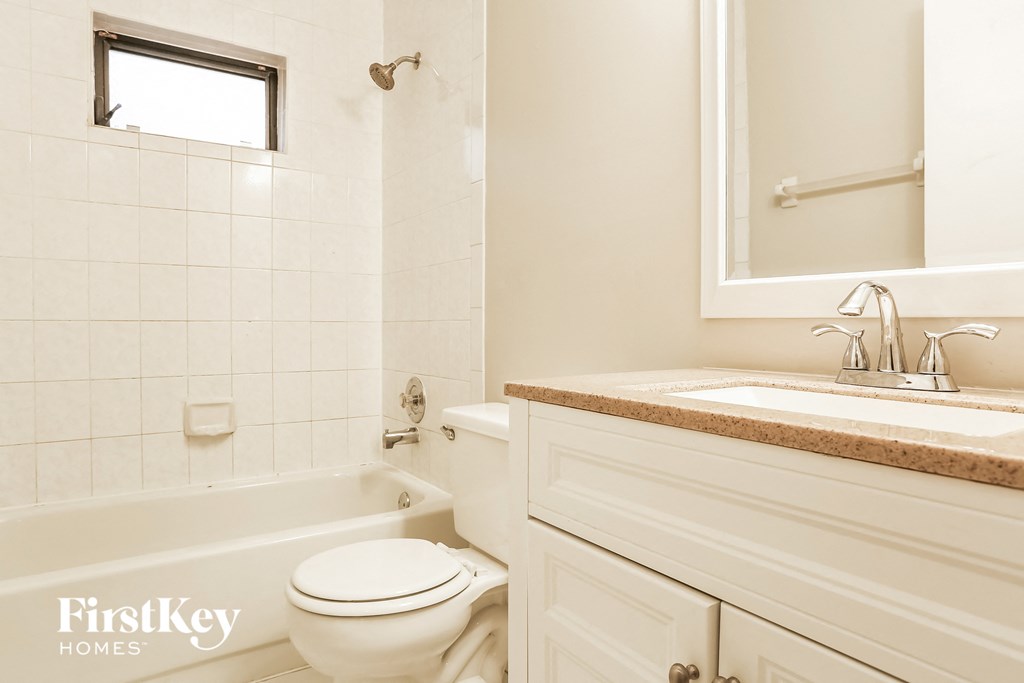 a bathroom with a toilet and a sink and a bath tub