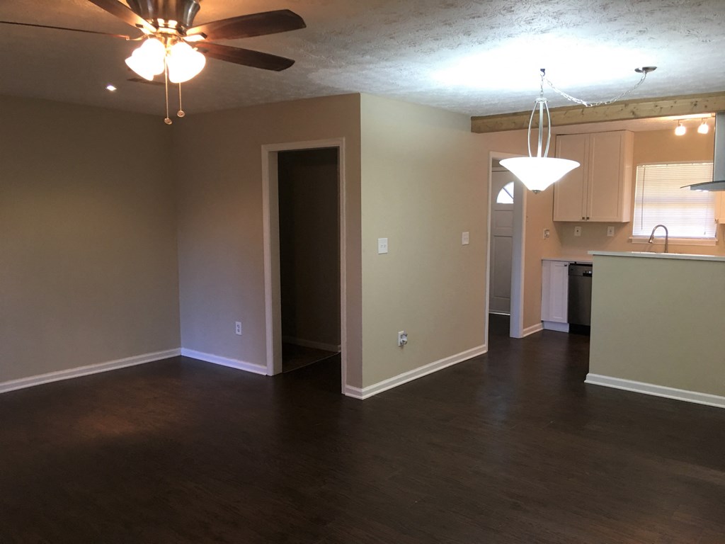 A room with a ceiling fan and a chandelier.
