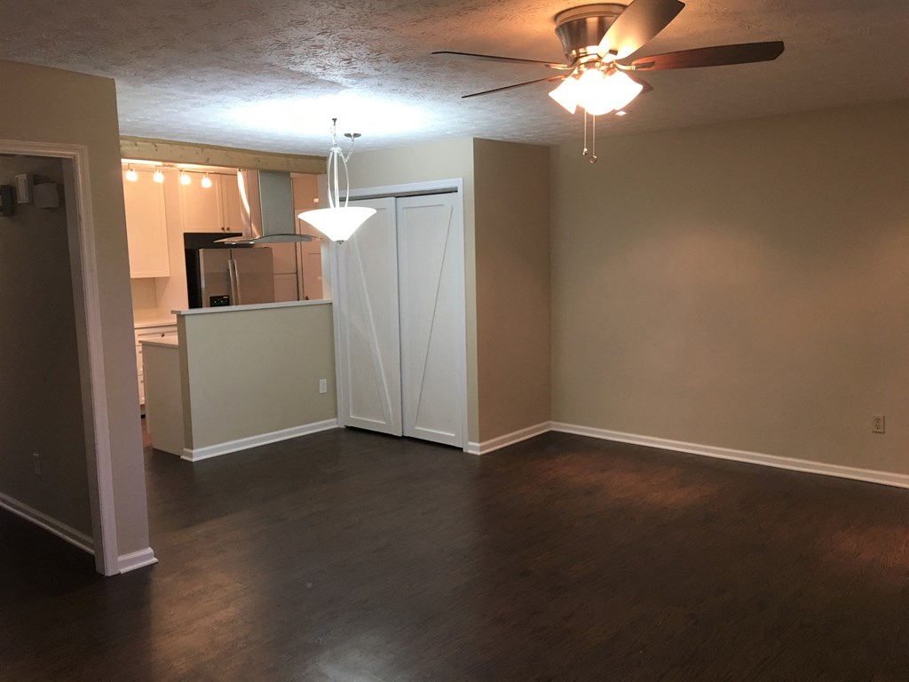 A room with a ceiling fan and a chandelier.