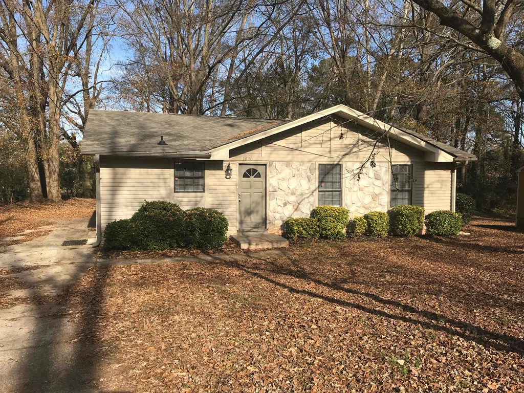 A house with a grey roof and a grey garage door.