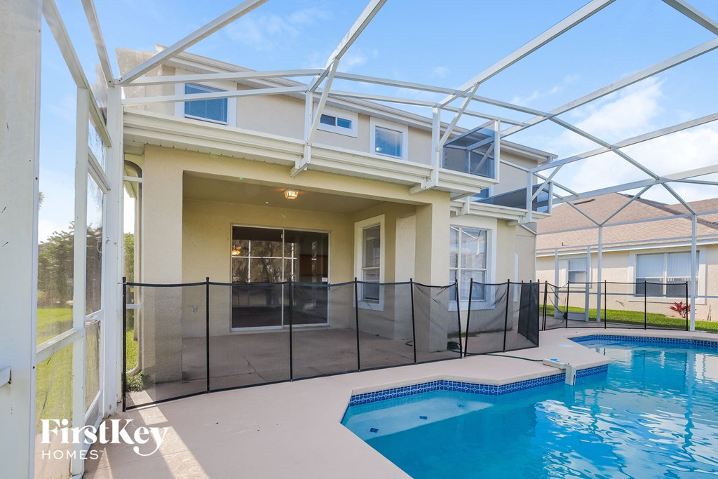 a patio with a pool and a house