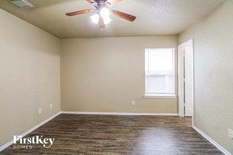 a living room with a ceiling fan and a window