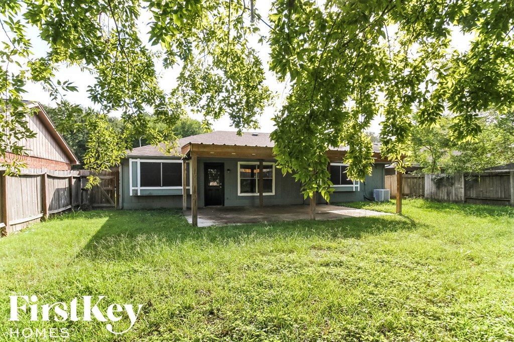 a small house with a yard and a tree