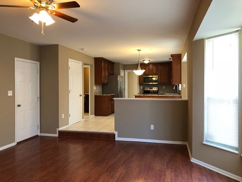 A kitchen with brown cabinets and a black stove top oven.