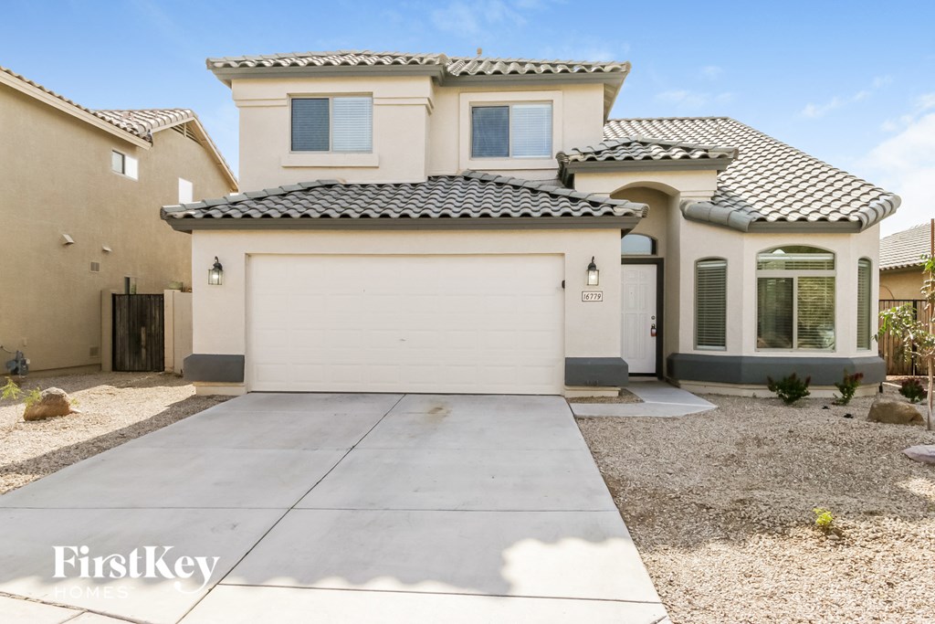 a house with a white garage door and a driveway