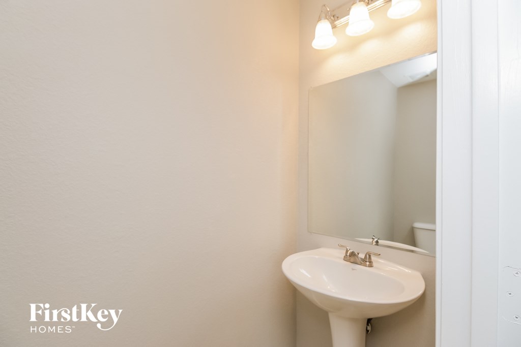 a white bathroom with a sink and a mirror