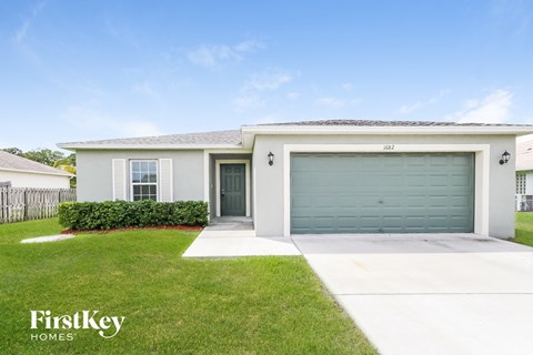 A house with a garage door is for sale.