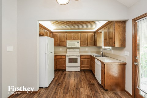 a kitchen with wooden cabinets and a white refrigerator