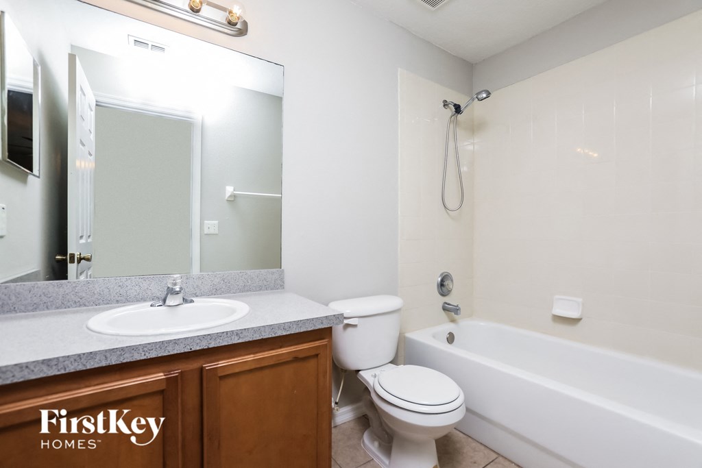 a bathroom with a sink toilet and a bath tub
