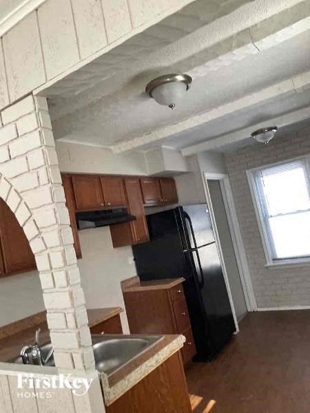 a kitchen with a sink and a refrigerator
