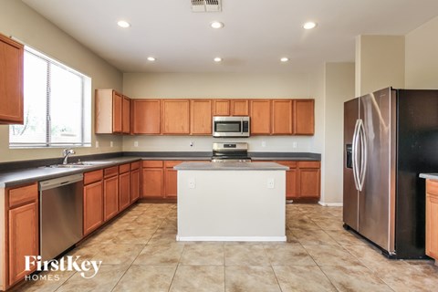 A kitchen with brown cabinets and a white island.
