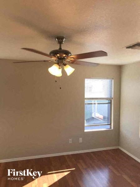 a living room with a ceiling fan and a window