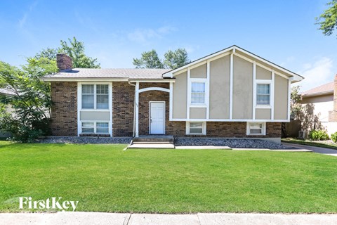 a small house with a lawn in front of it