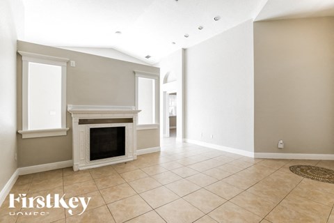 a living room with a fireplace and a tiled floor