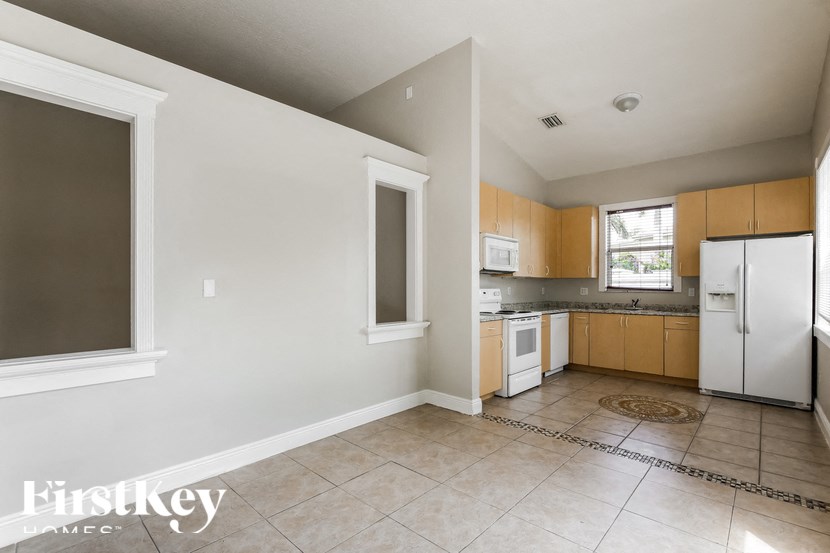 a kitchen with white appliances and wooden cabinets