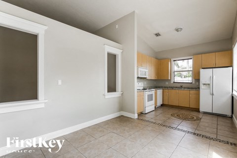 a kitchen with white appliances and wooden cabinets