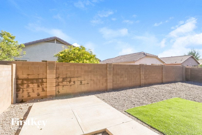 a retaining wall with a house behind it