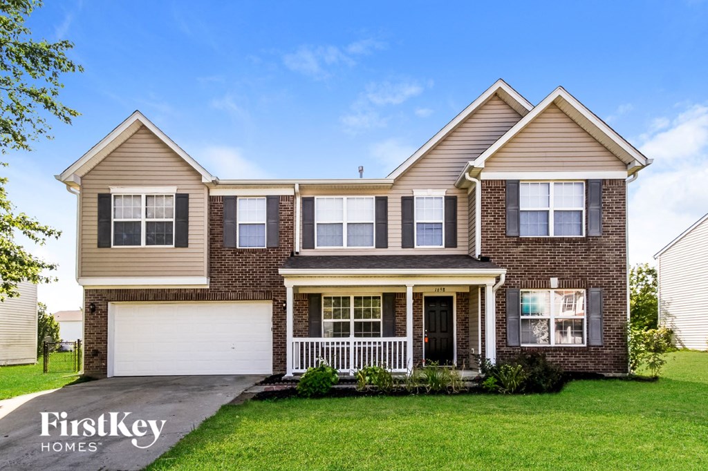 a large brick house with a white garage door