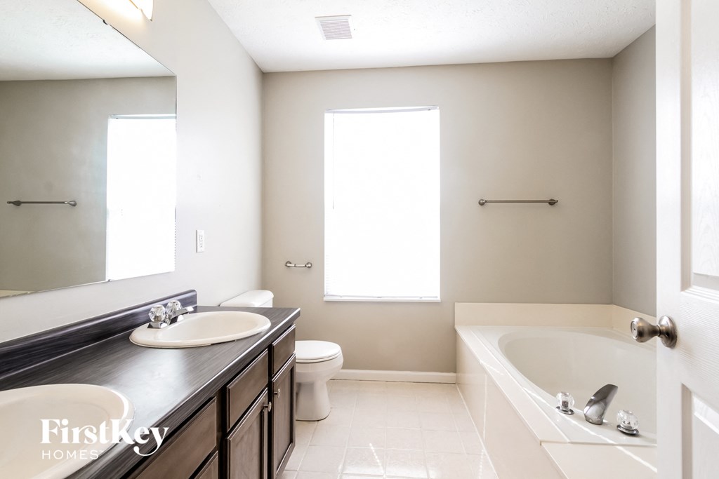 a bathroom with a sink and a tub and a toilet