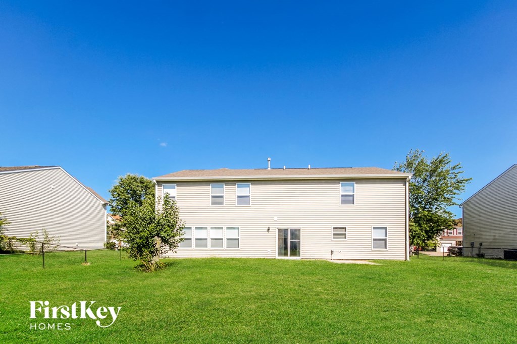 a house with a green lawn and a blue sky