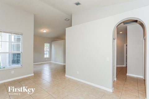 the living room and dining room with arched doorways