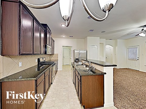A kitchen with a FirstKey Homes logo on the counter.