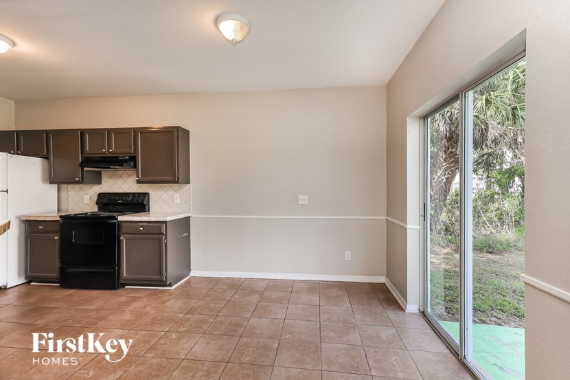 A kitchen area with a black oven and stove top is shown.