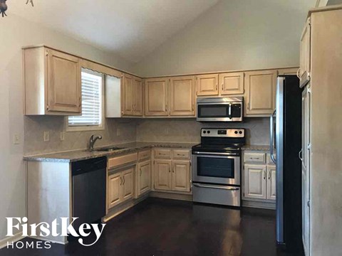 A kitchen with wooden cabinets and stainless steel appliances.