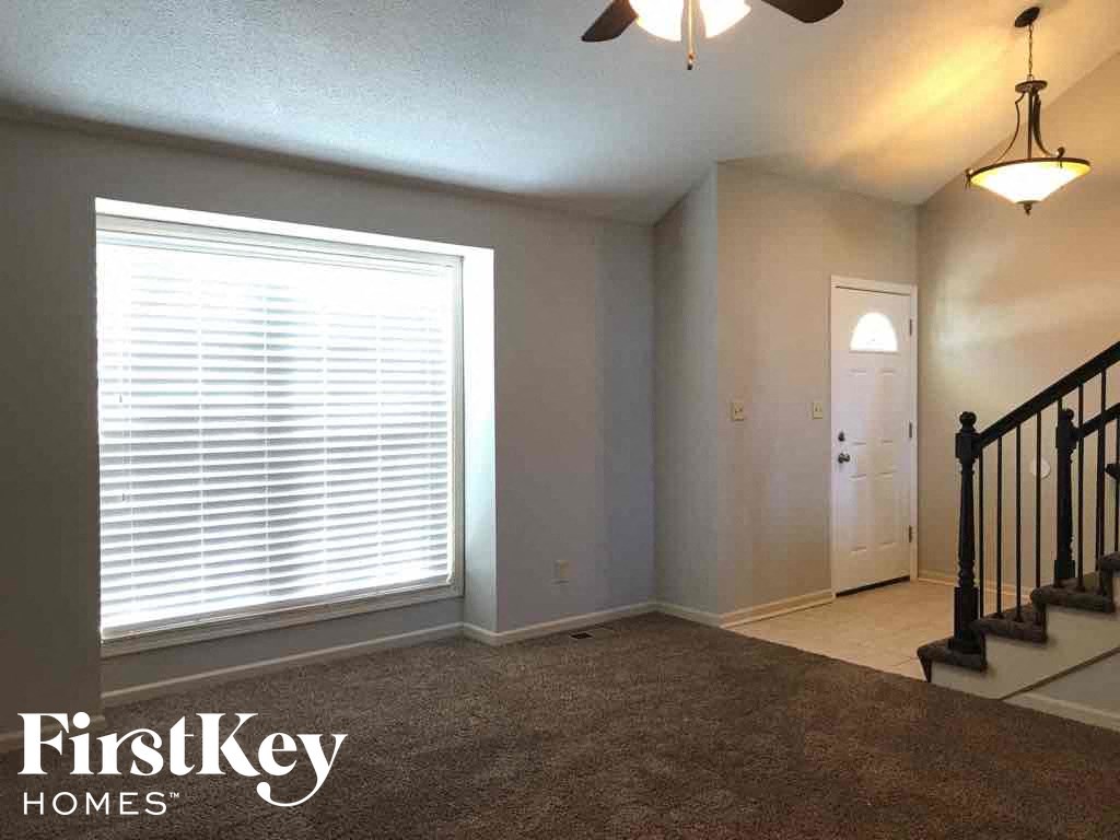 A room with a staircase and a door is shown.