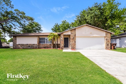 A house with a garage and a driveway is for sale.