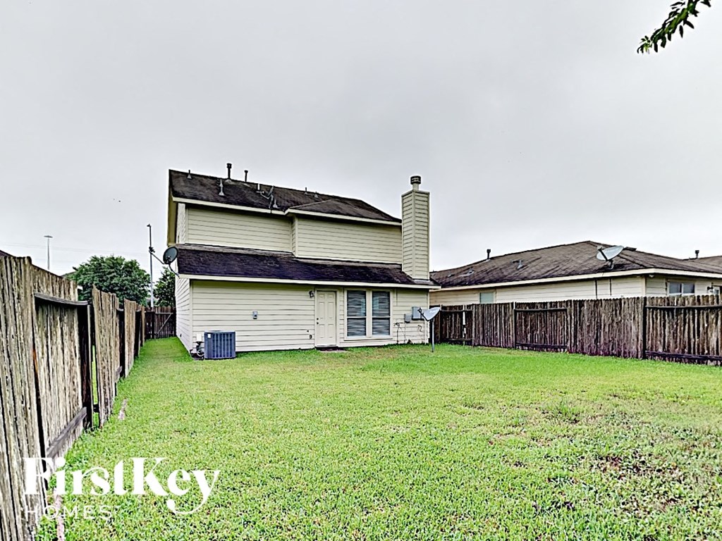 the backyard of a house with a yard and a fence