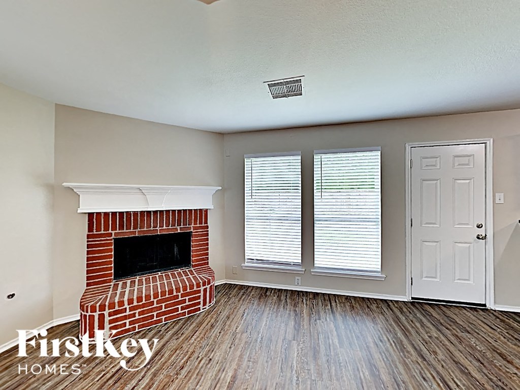 a living room with a fireplace and a white door