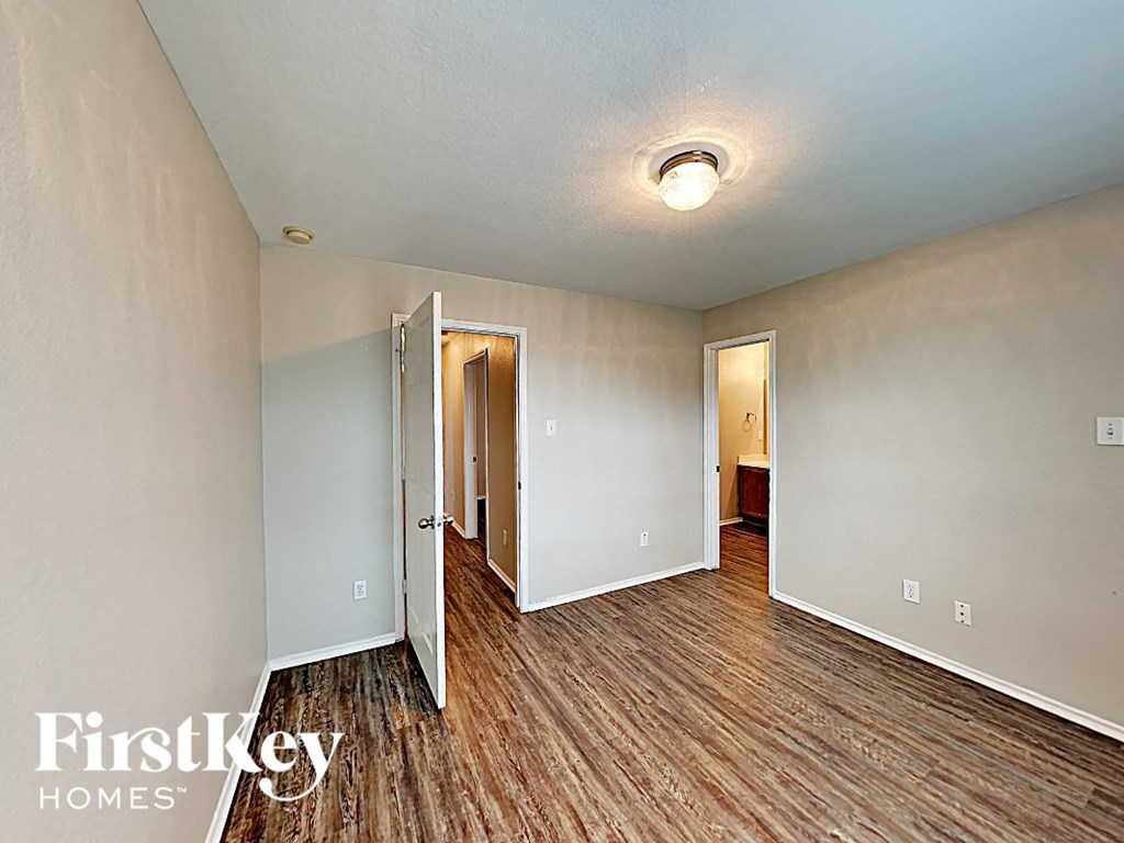 an open living room with wood flooring and white walls