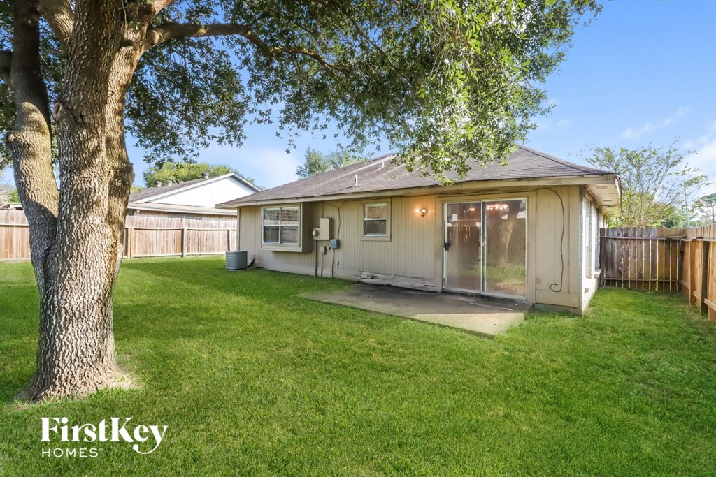 a small house with a yard and a tree