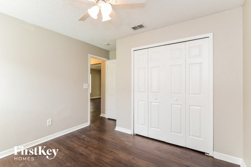 the living room and dining room of an empty house with white walls and wood floors