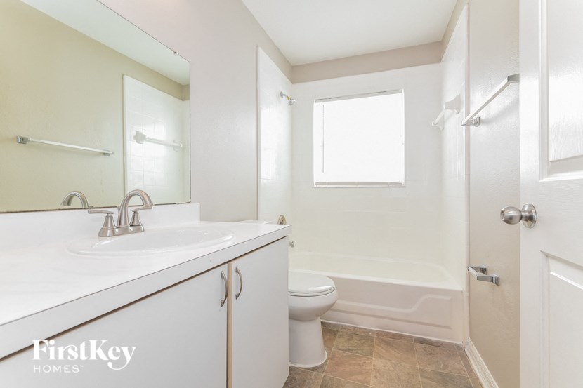 a bathroom with a sink toilet and a shower
