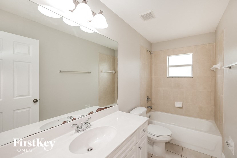 a bathroom with a sink and a toilet and a tub