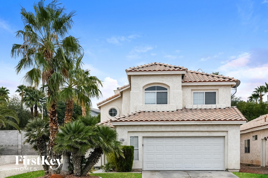 A house with a palm tree in front of it.