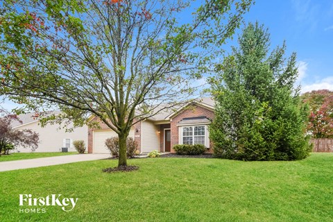 A house with a tree in front of it.