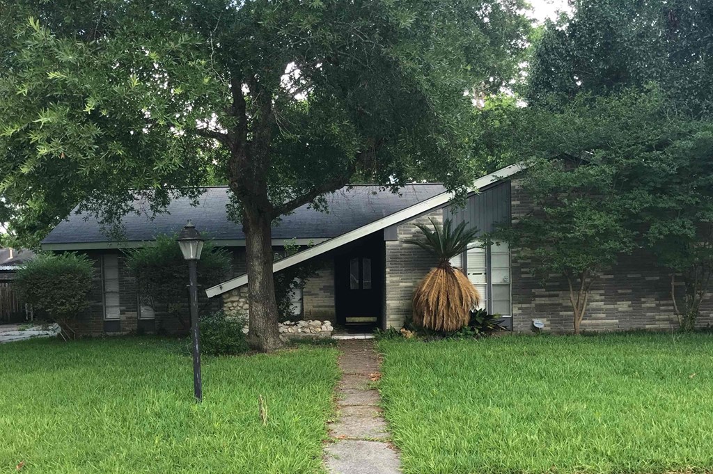 A house with a tree in front of it.