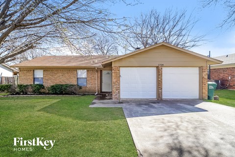 a small brick house with a white garage door