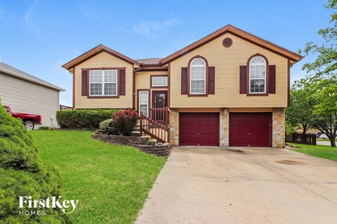 a yellow house with a red garage door