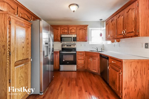 a kitchen with wooden cabinets and stainless steel appliances